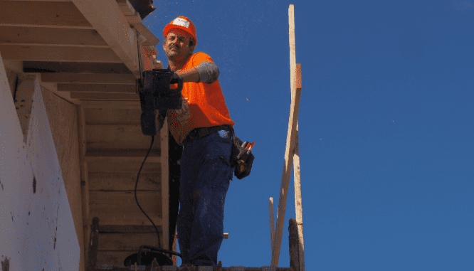 a person building their own carriage house.