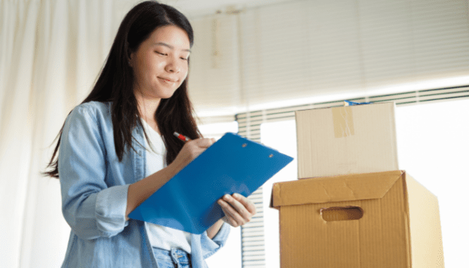 A woman checks off a list of tasks while deciding whether or not to add on or move.