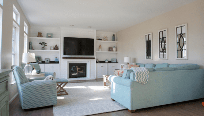 A living room with a white fireplace.