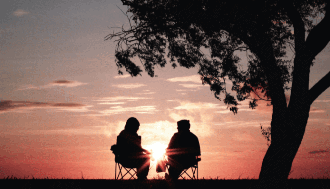 An image of a couple sitting under a tree to demonstrate what a first-time homebuyer tax credit is.