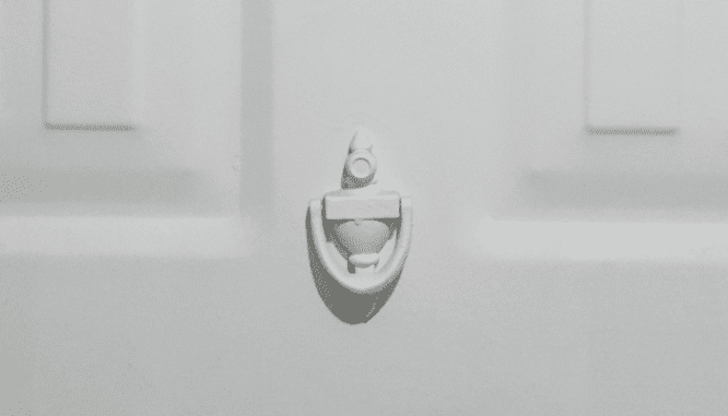 A door knocker outside of a house.