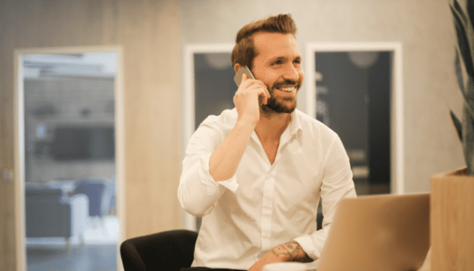 A person on their phone, potentially stopping or transferring utilities when they sell their home.