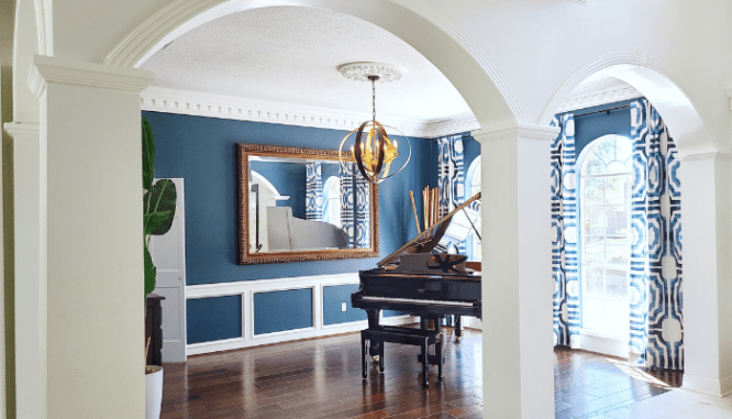 A mirror placed across from a piano is one way to decorate with mirrors.