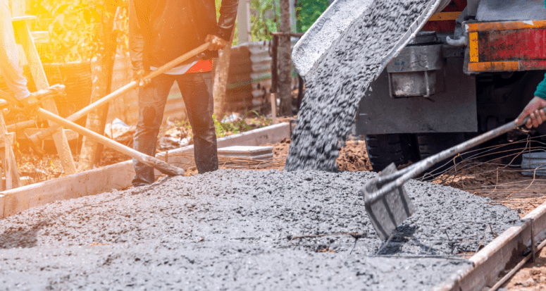 A cement mixer pours fresh cement for a driveway which is one way how to fix driveway cracks.