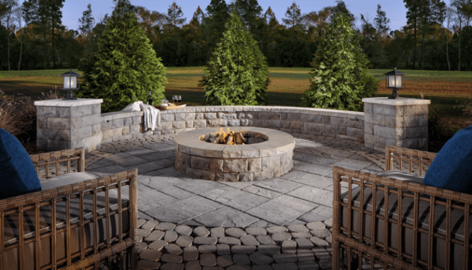 A fire pit that is part of an outdoor room.