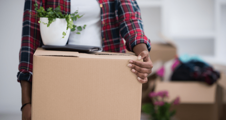 A person carrying a moving box.