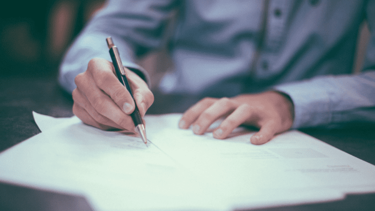 An image of a home buyer signing a jumbo loan