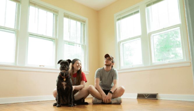 a couple in their new house, contemplating homeowners expenses.