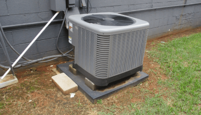 A new HVAC unit installed to replace an older one.