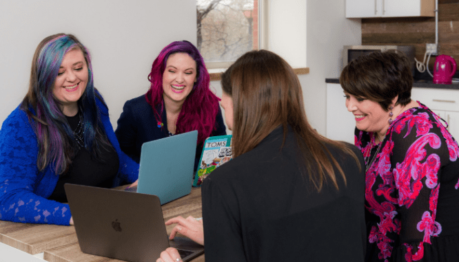 A team of people helping a woman decide whether to save for a house or invest.