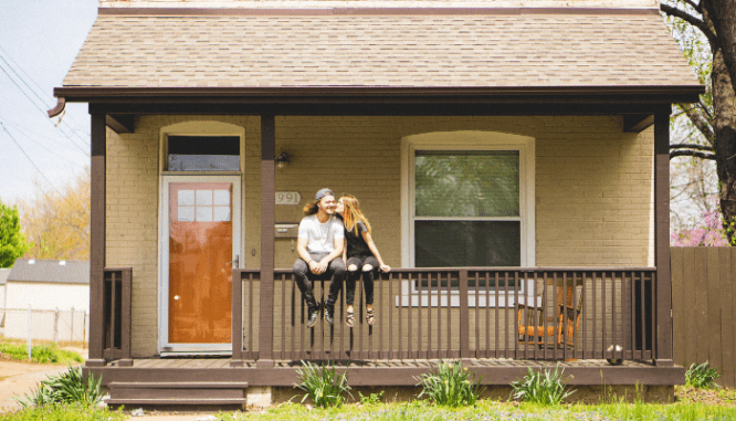 A couple in front of their tiny house.