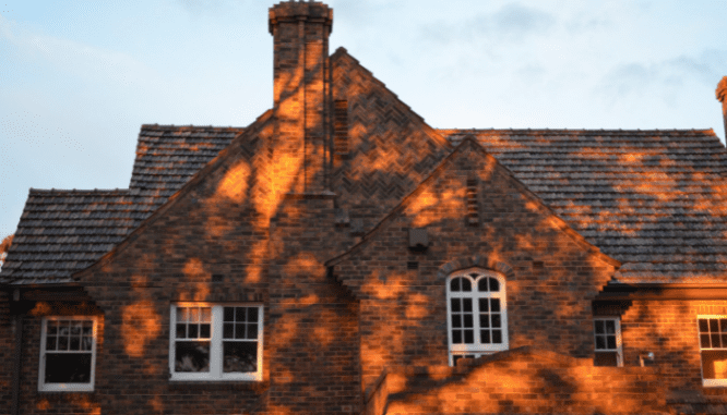 An image of a brick house used to depict who pays for what when selling a house.