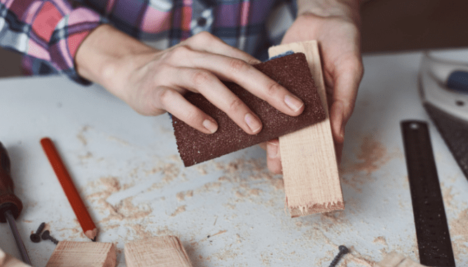 Sandpaper used to remove paint from wood trim.