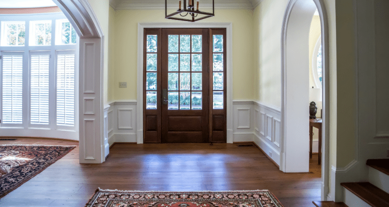 An entry of a house that has wainscoting.