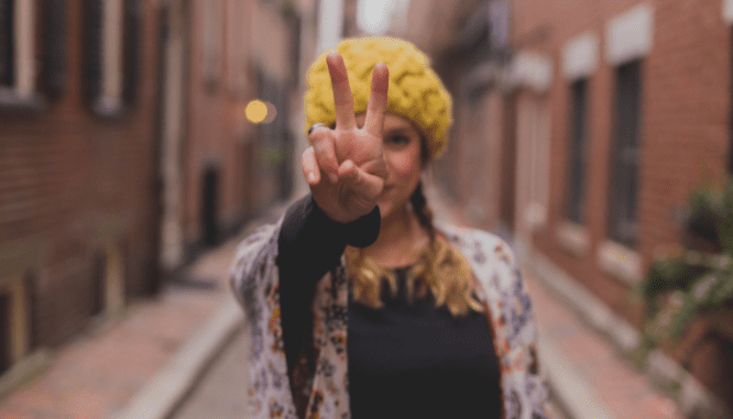 A woman holding up two fingers to represent closing cost options.