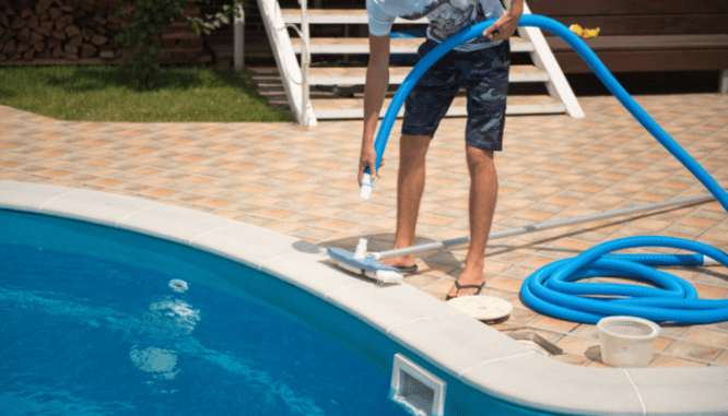 A person doing maintenance on a pool, a consideration as to whether or not a pool increases home value.