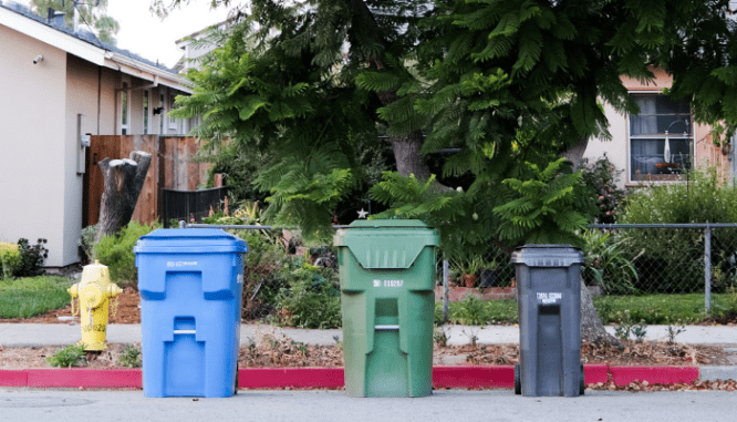 Garbage cans that are left on a street according to hoa rules.