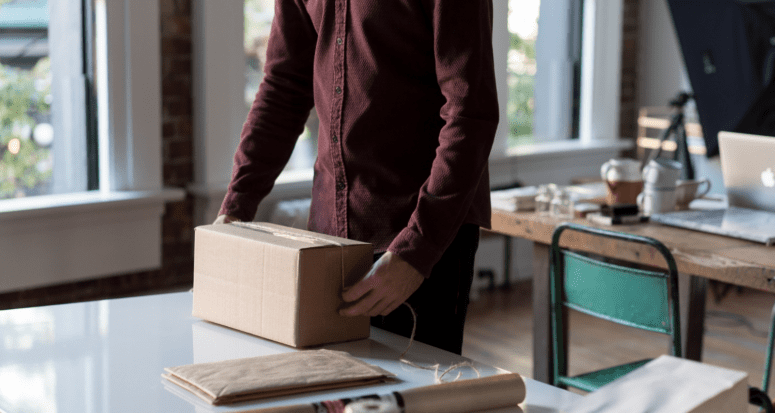 A man packing small items early to help make moving easier.