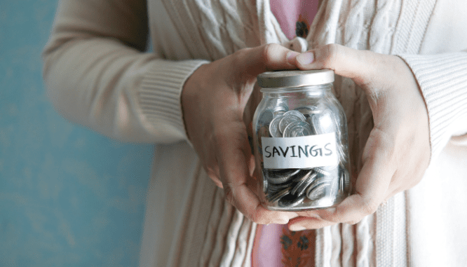 A woman using a jar to save up for a house in 6 months.