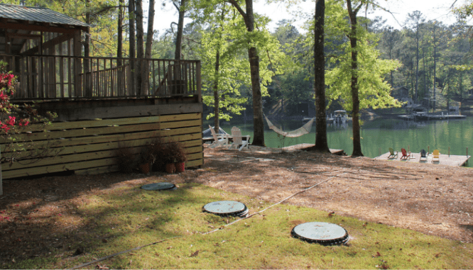 A house with a septic system next to it.