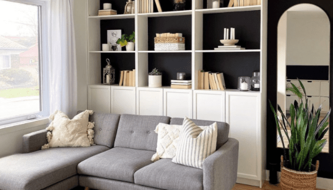 A small living room displaying a floor-to-ceiling bookshelf idea.