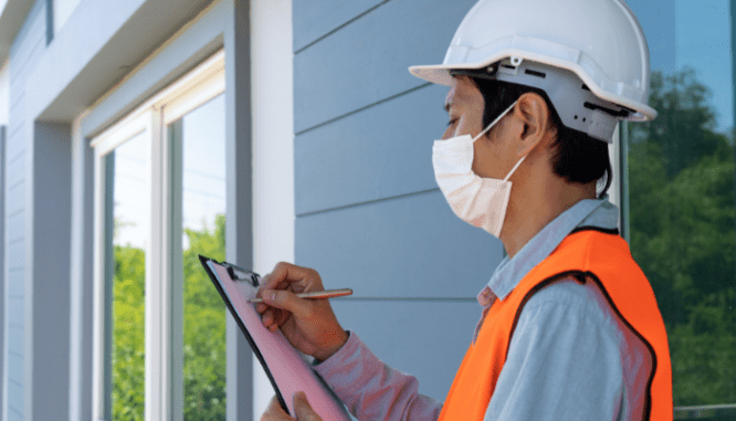 A home inspector reviewing their checklist for a home inspection.