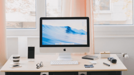 A desk with a computer used to research if a seller can raise the price of a house.