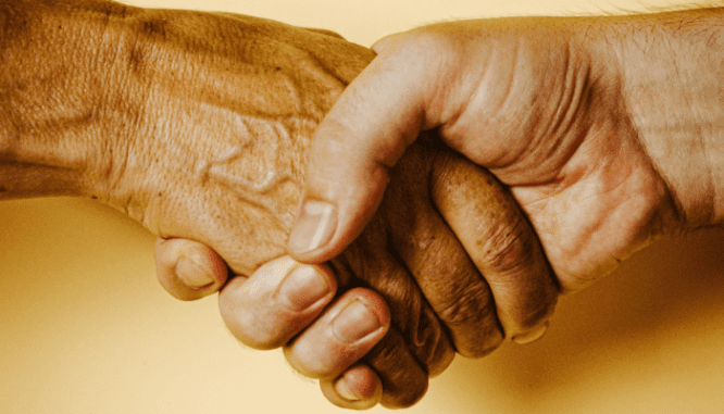 Two people shaking hands over their ibuyer sale.