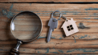 A magnifying glass and key to signify a home inspection.