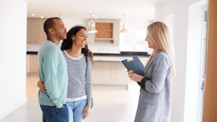 A Realtor showing a couple a house that's for sale.