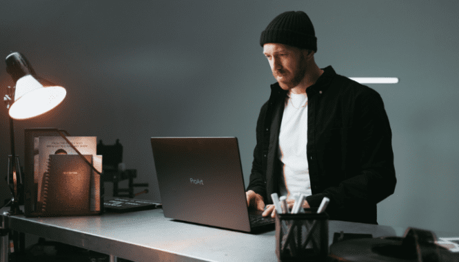 A man using his laptop to see if homeowners insurance is tax deductible.