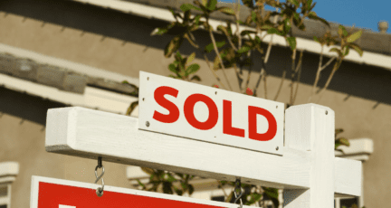 A sold sign on a house cleaned out to sell.