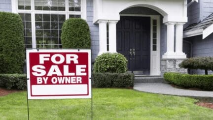 A house with a FSBO sign.