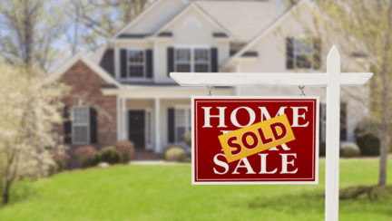 A house with a sold sign.