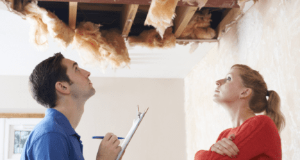 A home inspector looking at the ceiling of a house.