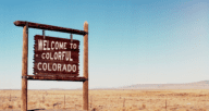 The welcome to Colorado sign, a state where there are real estate companies.