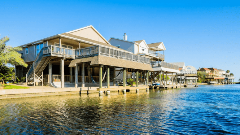 An image of a house near the ocean to demonstrate how to sell a house that has flooded.