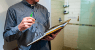 A man with a clipboard performing a free home inspection.
