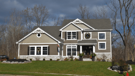 brown and gray house on a hill showing how much money you could keep after selling a house