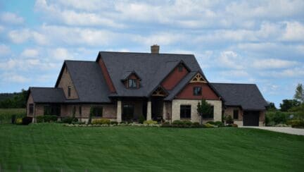 A nice estate home with manicured lawn and what it would cost to sell a house like this in Texas.