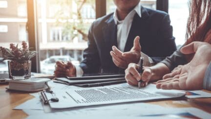 A group of people signing a real estate contract.