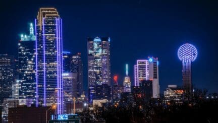 The Dallas skyline at night, where many cash home buyers are moving and working.