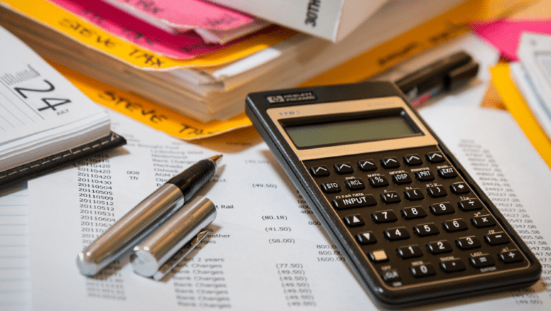 A stack of tax paperwork related to a cash home purchase.