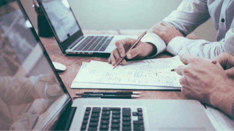 An image of two people working with laptops that represents working with a home investor