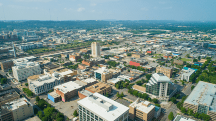 Aerial drone image of Downtown Alabama USA that represents We Buy Houses