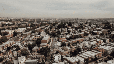 Aerial view of Queens, NY where homeowners may be interested in the services of a we buy houses company