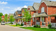 An image showing a row of houses in a neighborhood.