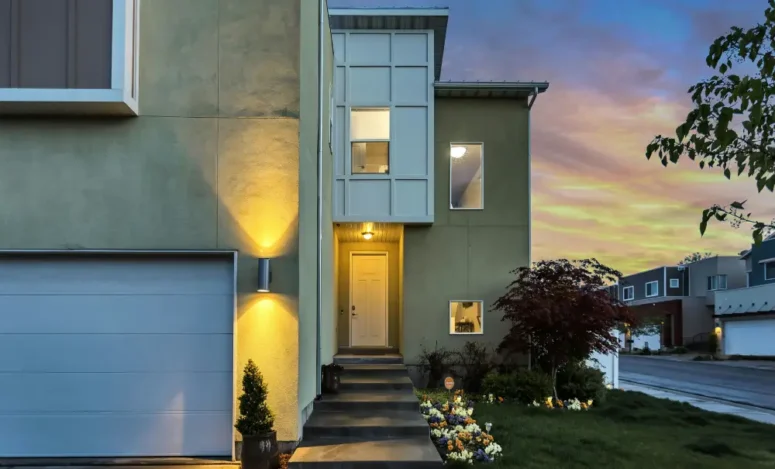 a photo of a house at twilight related to comparing a house with a condo