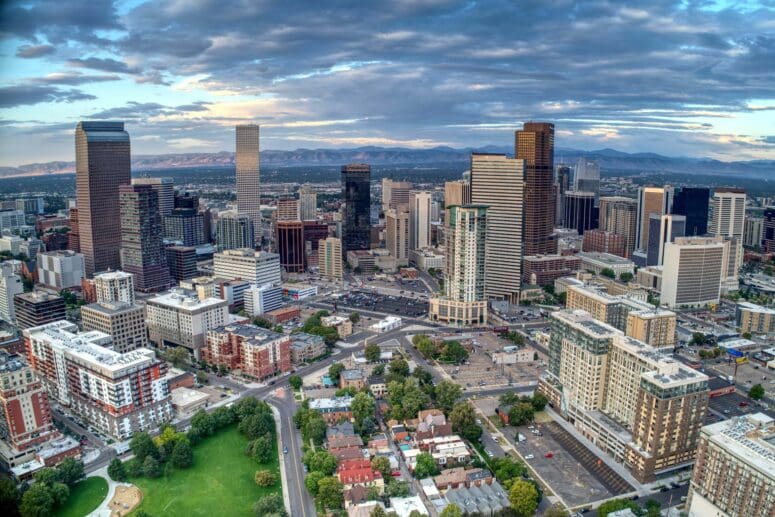 Daybreak over downtown Denver with a view of the Rocky Mountains to the west.