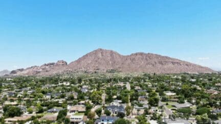 A view of Camelback Mountain and the suburban neighborhoods below it from an elevated vantage point.